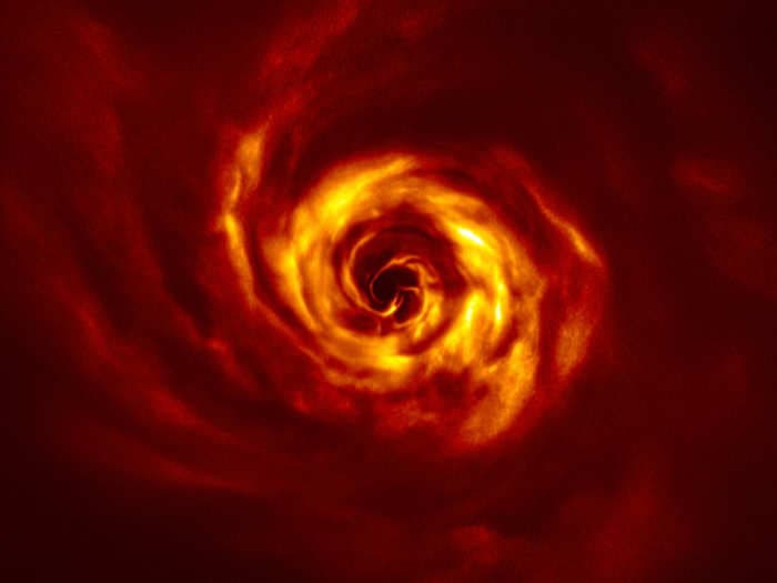 In a fiery swirl of orange gas, a new planet is born — witnessed by astronomers for the very first time
