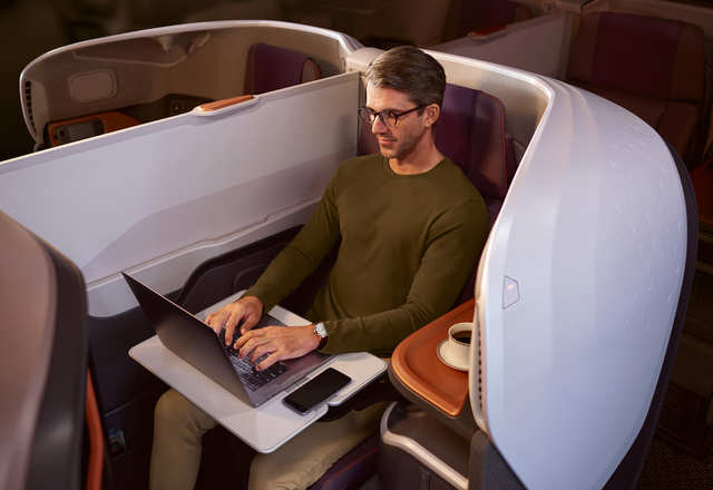 Each business class seat is 25-inches wide with 50 inches of pitch and is cocooned inside a carbon composite shell for added privacy. The seats also convert into a 78-inch long bed. Like the suite, the business class seat is also upholstered by Poltrona Frau.