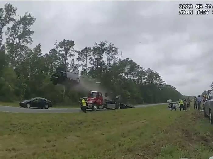 Police video shows a car flying off a tow-truck ramp at full speed on Georgia highway — watch here