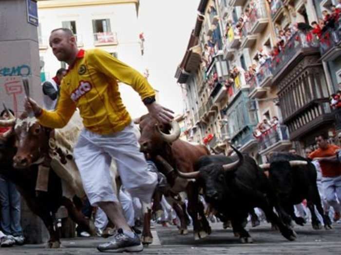 Here's why people make the crazy decision to run in front of a herd of bulls in Spain every year