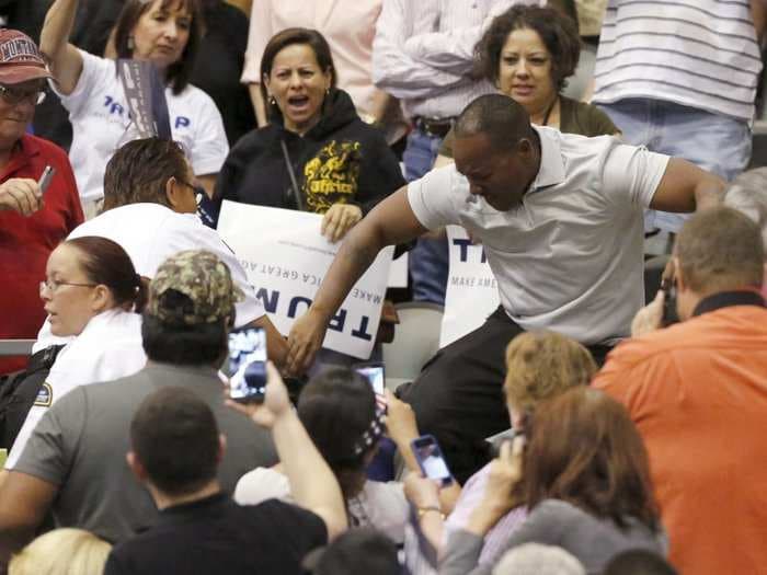 Protester kicked, punched while being escorted out of a Donald Trump campaign rally in Arizona