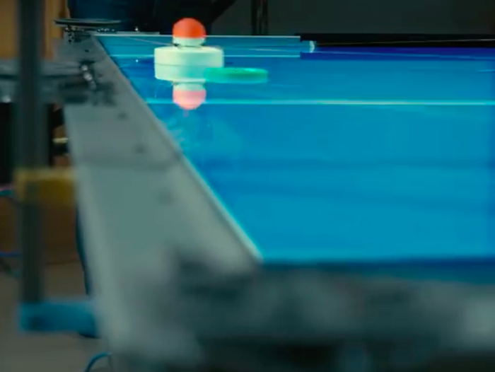 A $30 billion hedge fund had staff program a robot to play air hockey in the hope it would make them better at making money