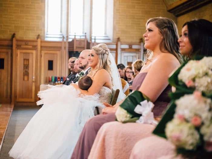 A bride is going viral for a photo of her breastfeeding at her wedding