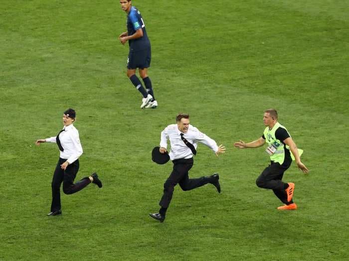 Fans rush the field during one of the most thrilling segments of the World Cup Final and stop play
