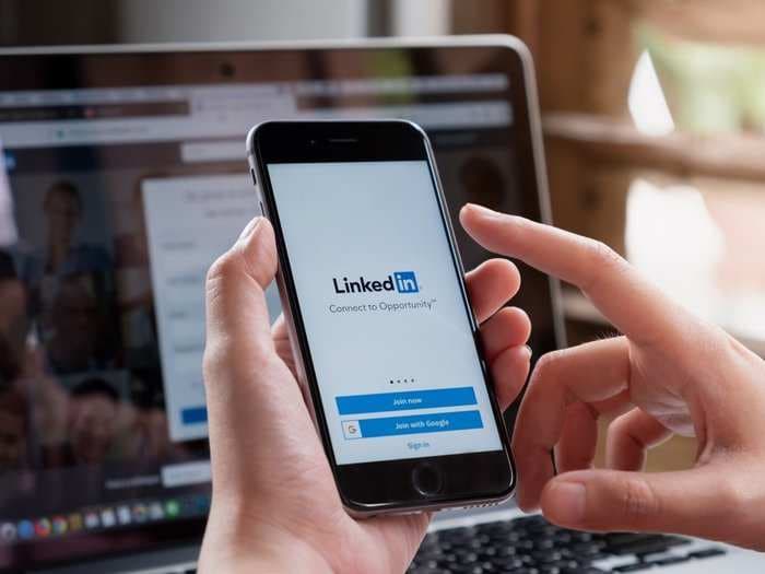 How to add a promotion on your LinkedIn profile on desktop or mobile, and share your new job title with your network
