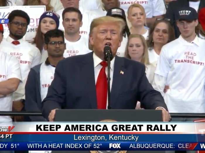 Trump speaks at a Kentucky rally in front of supporters with 'READ THE TRANSCRIPT' shirts