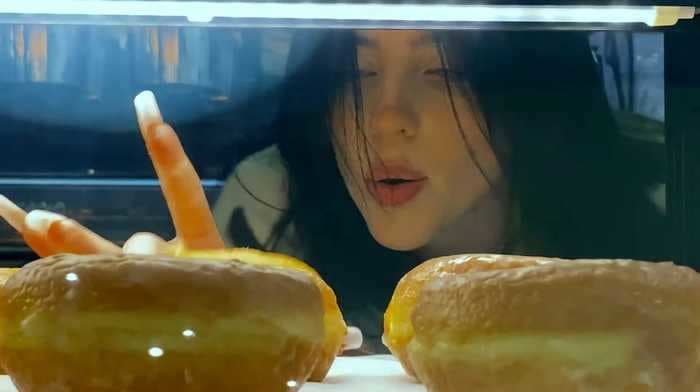 Watch Billie Eilish collect a food-court feast and dance around an empty mall in the music video for her new song 'Therefore I Am'
