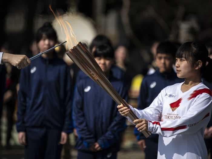 'I am going to run with a smile': Tsunami survivors carry Olympic flame in Tokyo Games torch relay