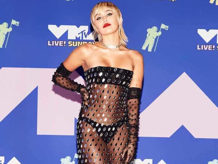 21 of the most daring looks Miley Cyrus has ever worn, from see-through dresses to a glitter-covered suit