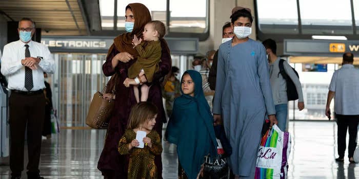 A slow process for screening evacuees arriving to the US has meant Afghans are waiting for hours on parked planes