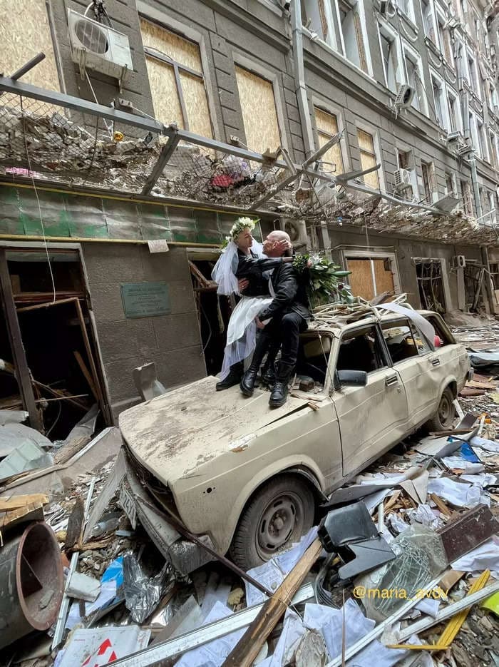 Striking photos show a Ukrainian bride and groom moments before they got married amid rubble