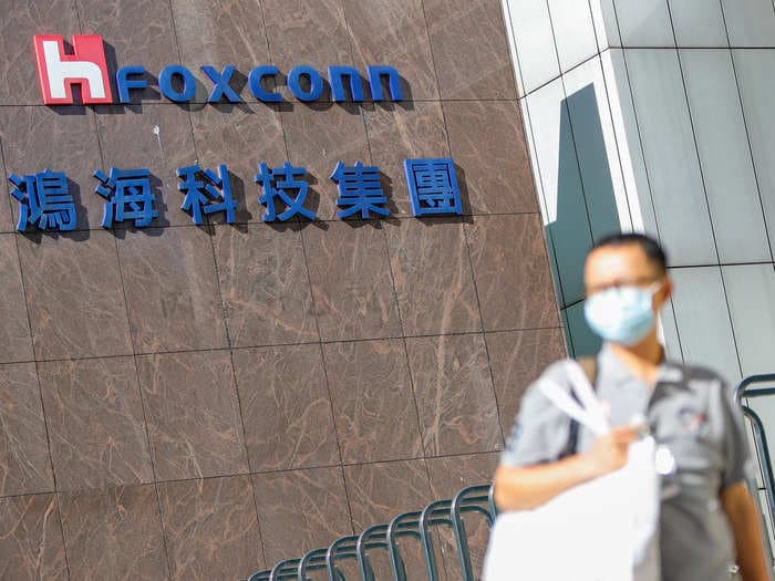 Workers are fleeing from Foxconn, China's biggest iPhone factory, by climbing over fences and walking down highways on foot amid COVID fears, photos and videos show