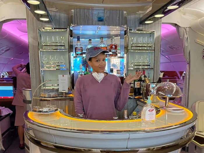 I splurged my miles to fly Emirates' luxe business class. I ate a multi-course meal, lounged at the in-flight bar, and learned the seat upgrade is worth it.