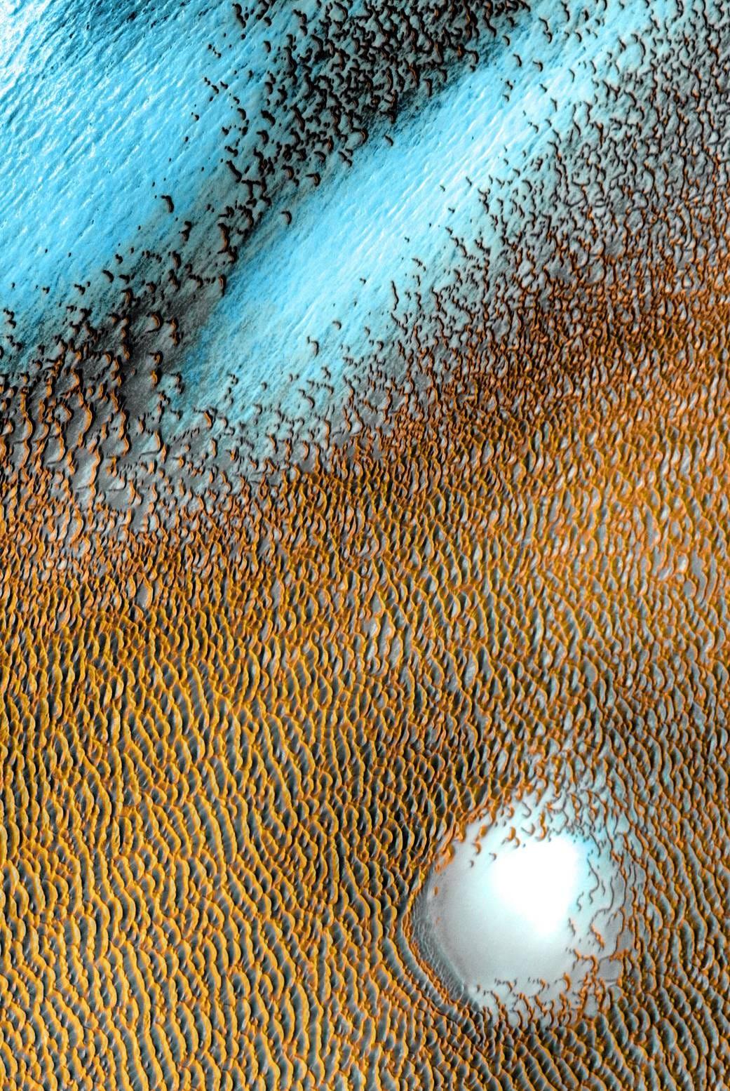 NASA shares breathtaking image of a wind-sculpted sea of blue dunes on