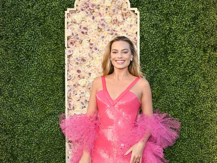 Margot Robbie's dazzling pink gown and fishnet boa was inspired by Superstar Barbie.