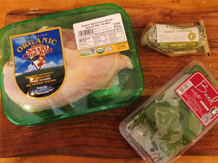 I started by gathering my ingredients, which included skin-on chicken breasts, herb goat cheese, and fresh basil. 