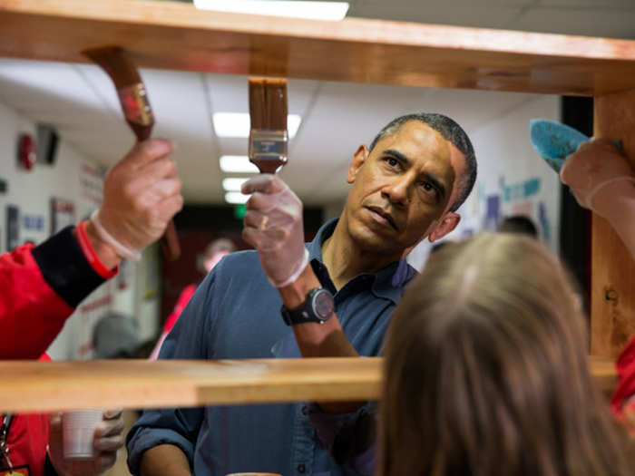 President Barack Obama stains shelves during a National Day of Service school improvement project at Burrville Elementary School in Washington, D.C., Saturday, Jan. 19, 2013. The First Family kicked off events for the 57th Presidential Inauguration by joining in the National Day of Service.