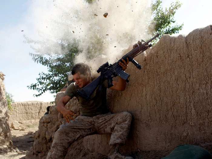 Sgt. William Olas Bee, a U.S. Marine from the 24th Marine Expeditionary Unit, has a close call after Taliban fighters opened fire near Garmser in Helmand Province of Afghanistan in May of 2008.