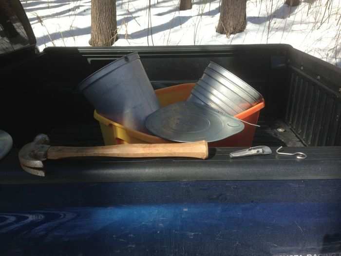 Maple syrup is made from the sap of maple trees. So you have to collect that sap. You start with some gear — buckets, taps, hooks, a drill, a hammer, and a tank. A pickup truck helps.