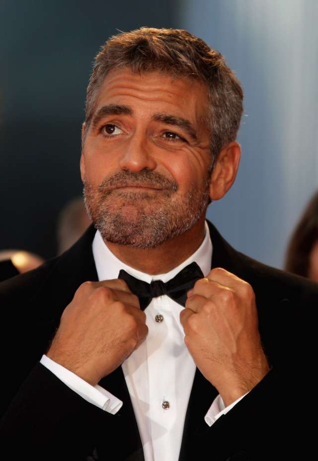 Don't listen to GQ - George Clooney is still incredibly stylish and these 15 photos prove it He-is-forever-adjusting-his-bow-tie-and-making-faces-on-the-red-carpet-