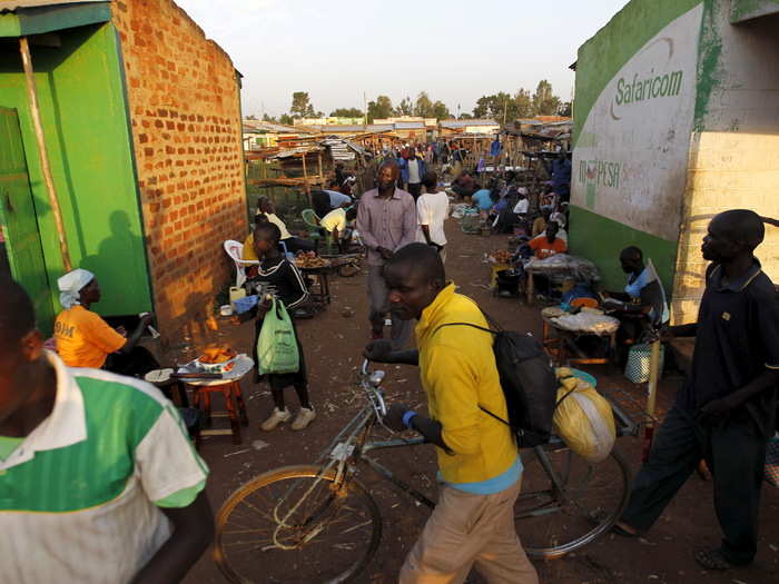 People hurry through the busy trading center in the village of Kogelo, west of Kenya's capital Nairobi.