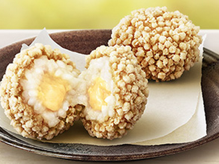 McDonald's Japan serves rice cheese balls. The menu items have a crispy outside with a warm, gooey inside.