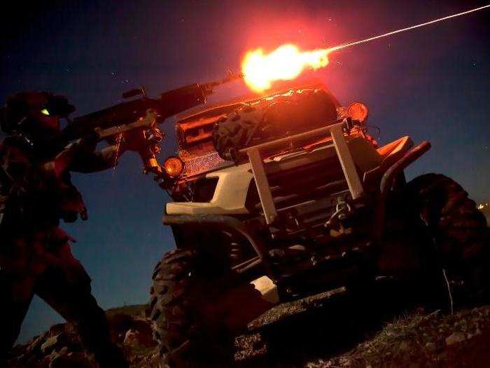 A Marine Special Operations Team member fires a M240B machine gun during night fire sustainment training in Helmand province, Afghanistan.