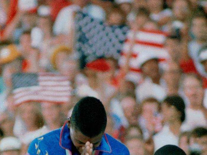 Carl Lewis receives the first of his eventual four gold medals at the 1984 Games in Los Angeles.