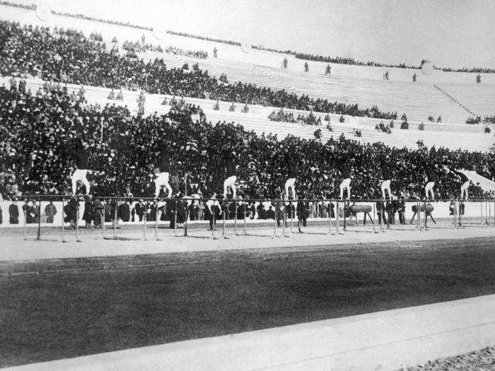 Athens, 1896: The 1896 games were the first international Olympic Games held in the modern era. They brought together the largest international participation of any event to that date, and the stadium sold out to massive crowds. In this image, members of the winning German gymnastics team show their routine on the parallel bars in front of spectators.