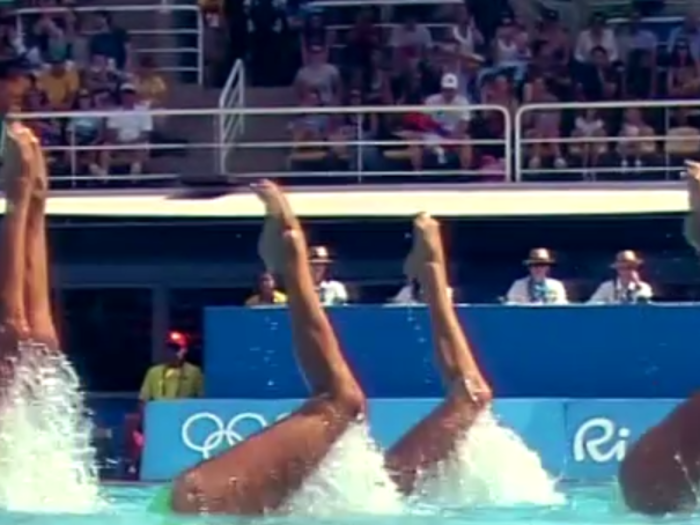 Members of team Italy extend their legs out of the pool...
