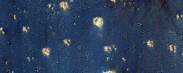 False colors assigned to certain minerals make Syria Planum an inky blue that's speckled with gold.