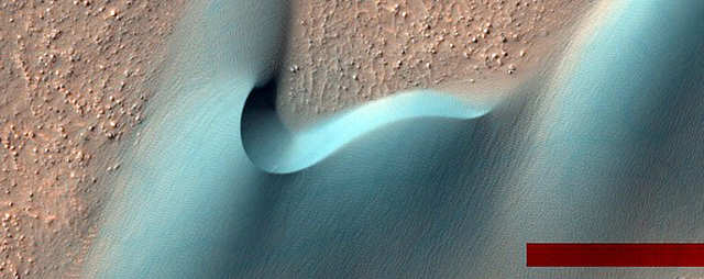 Dunes in a Martian crater. The red bar is an artifact of NASA's image processing.