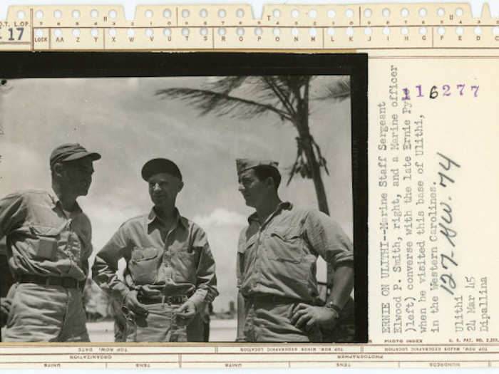 Marine Staff Sgt. Elwood P. Smith, right, and a Marine officer, converse with Pyle when he visited this base of Ulithi on March 24, 1945.