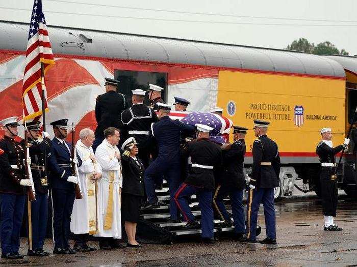A join services honor guard carries casket of former President George H.W. Bush onto train which carried him to College Station, Texas.