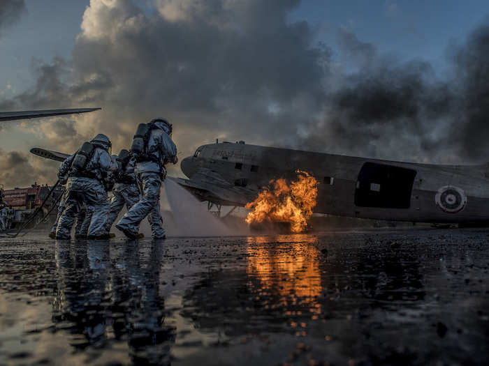 US Marine firefighters and Royal Thai firefighters work together to put out a simulated aircraft fire during Exercise Cobra Gold 2018 in Thailand in February 2018.