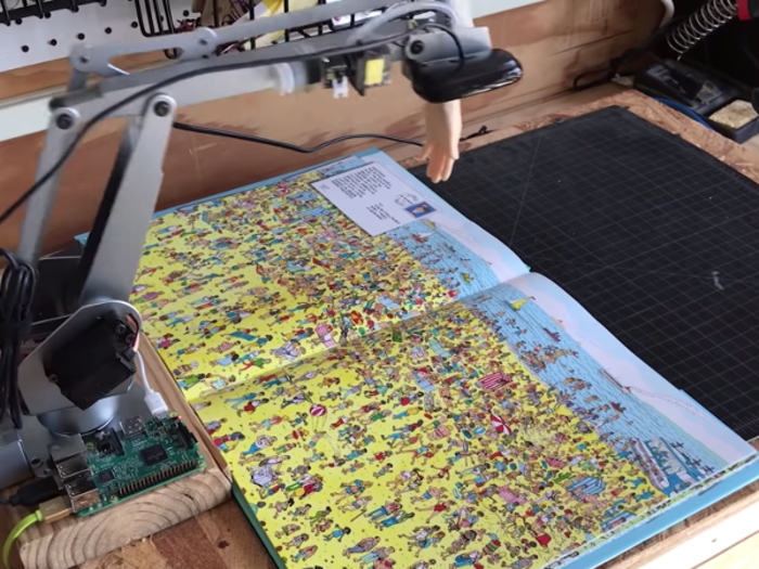 Creative agency redpepper built a camera-mounted robotic arm and connected it to Google's machine learning service AutoML, which analyzes the faces on any given page to find Waldo.