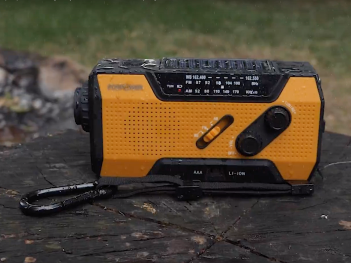 A hand-crank/solar-powered NOAA radio and charging device