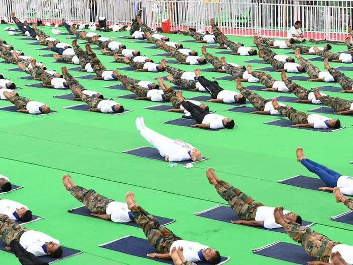 Modi performing yoga, along with 30,000 people at Prabhat Tara grounds in New Delhi on the occasion of the fifth International Yoga Day.