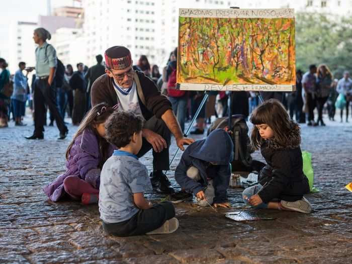 The demonstration began at the São Paulo Museum of Art, and art was a major feature in the protest. Here, kids paint to encourage preserving the Amazon Rainforest.