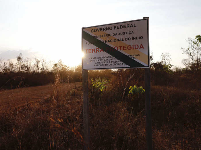 A government sign tells people the land ahead is protected, but for many indigenous peoples, such signs don't count for much anymore.