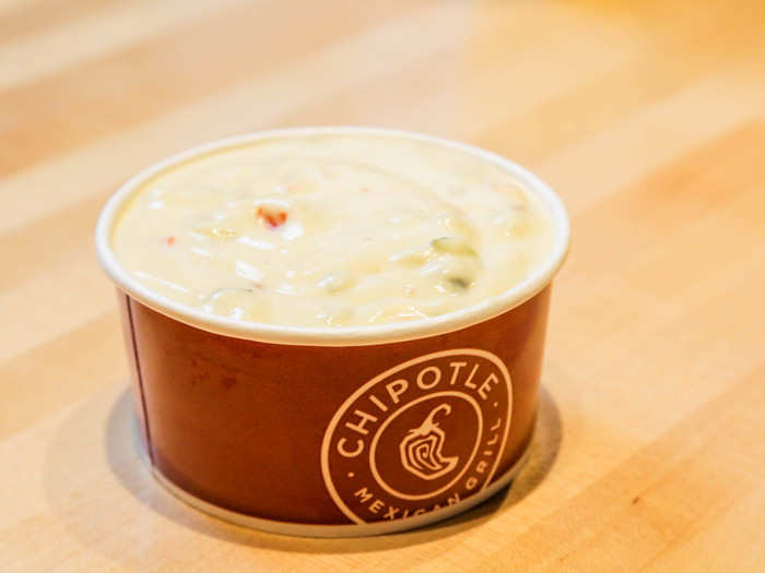 Chipotle's queso blanco is made with two types of aged cheeses and uses serrano, poblano, and chipotle peppers.