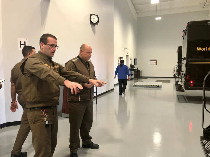 Inside a UPS training school where workers haul boxes across slick 'ice,'  perform high-stakes driving drills, and deliver packages to empty homes in  a mock neighborhood