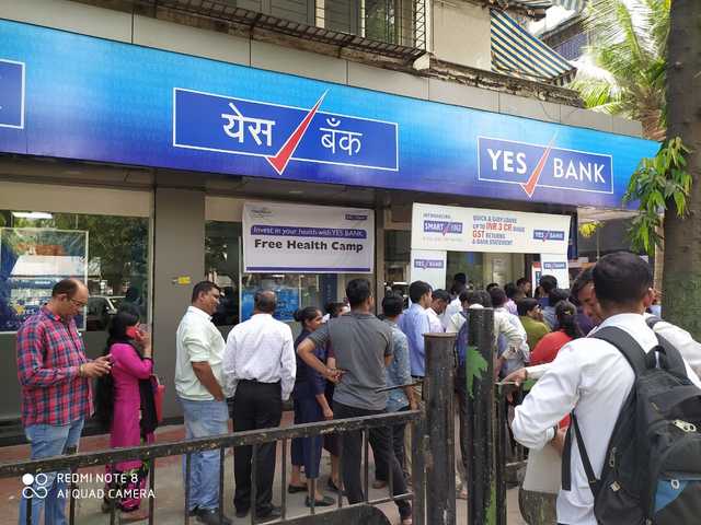 In pics: Customers of Yes Bank line up outside ATMs for cash