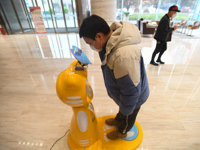 On March 11, robots in the Hunan province in China  conduct morning temperature checks.