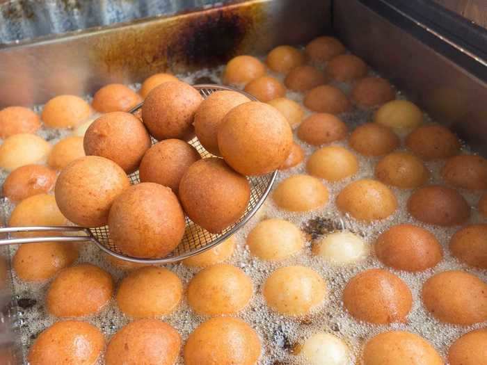 In South America, many people eat tiny buñuelos, which symbolize good luck.