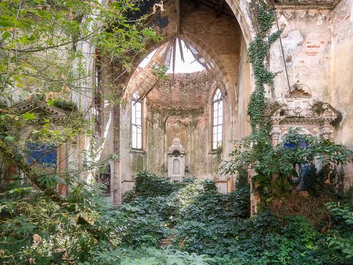 This abandoned 19th-century church in Italy has become overgrown with weeds and vines, but much of the original architecture still stands.