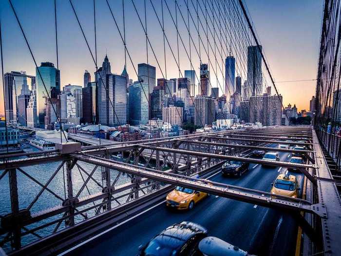 Driving across the Brooklyn Bridge provides stunning views of lower Manhattan.