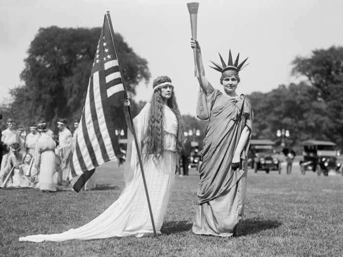 This Fourth of July photo was taken in 1919. Old-fashioned cars can be seen in the background.