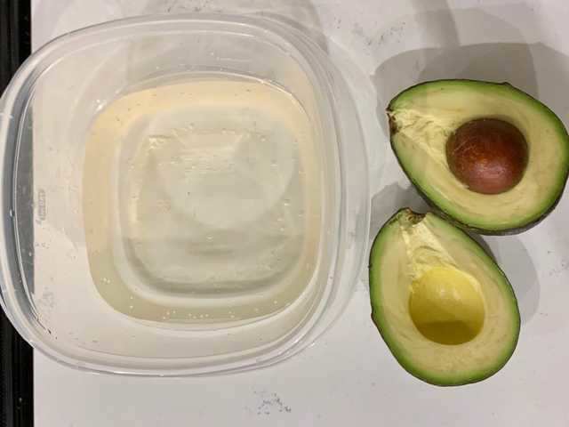 In the name of avocado storage perfection, I tested a hack that involves an unused half of the fruit, a container, and water.
