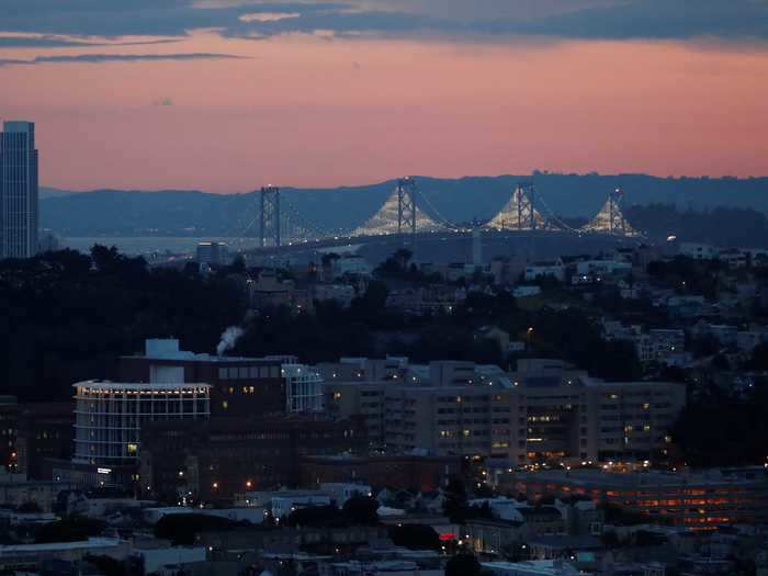 BEFORE: Sunrise illuminates Zuckerberg San Francisco General Hospital and Trauma Center, seen with the Bay Bridge in the background.